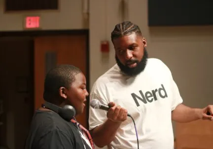 Lamont Holden holding mic up to another individual