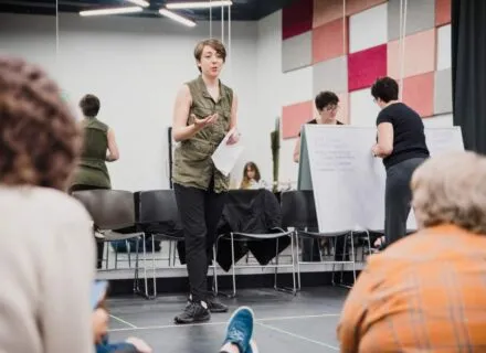 jessica standing in front of room of students teaching