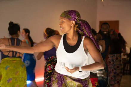 person dances with arms stretched out