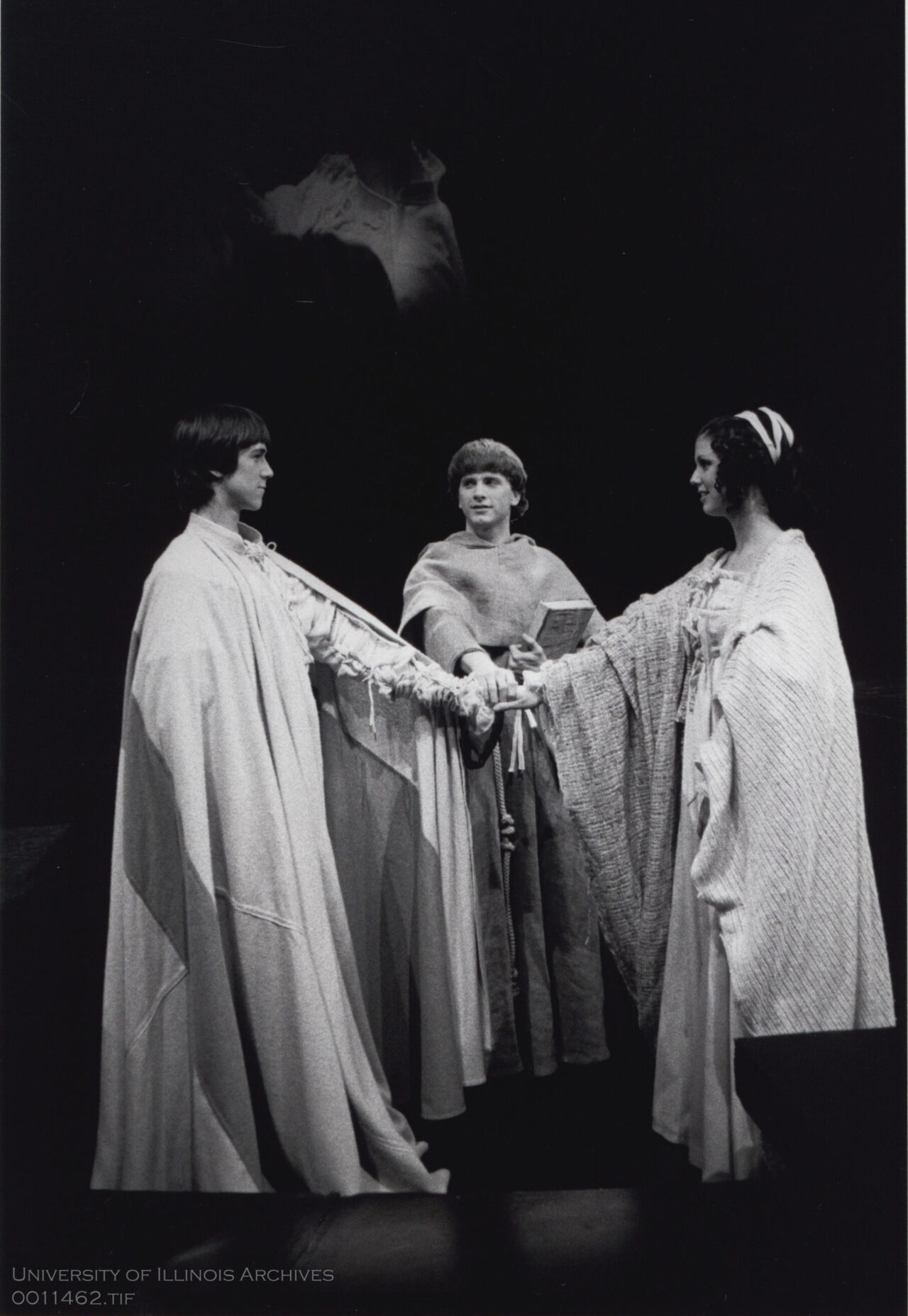 3 people with arms stretched to meet in the middle