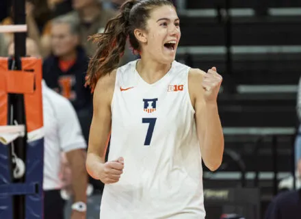 volleyball player in jersey pumps fist in victory