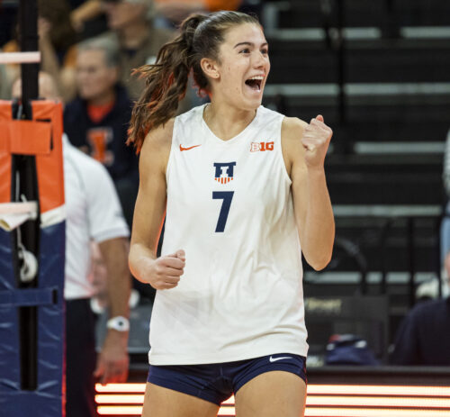 volleyball player in jersey pumps fist in victory