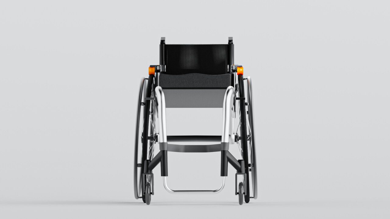 black and silver wheelchair with orange attachments