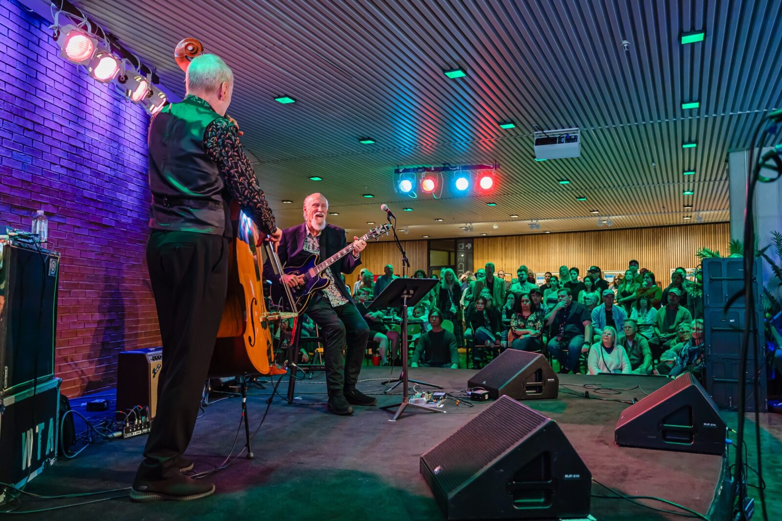 Two men playing music on stage
