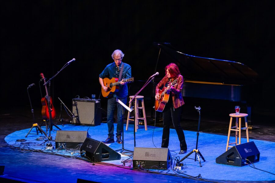 Man and woman on stage playing guitar