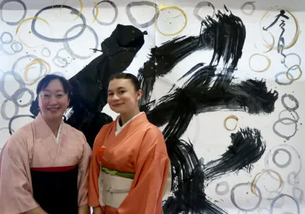 Two women standing in traditional Japanese garments