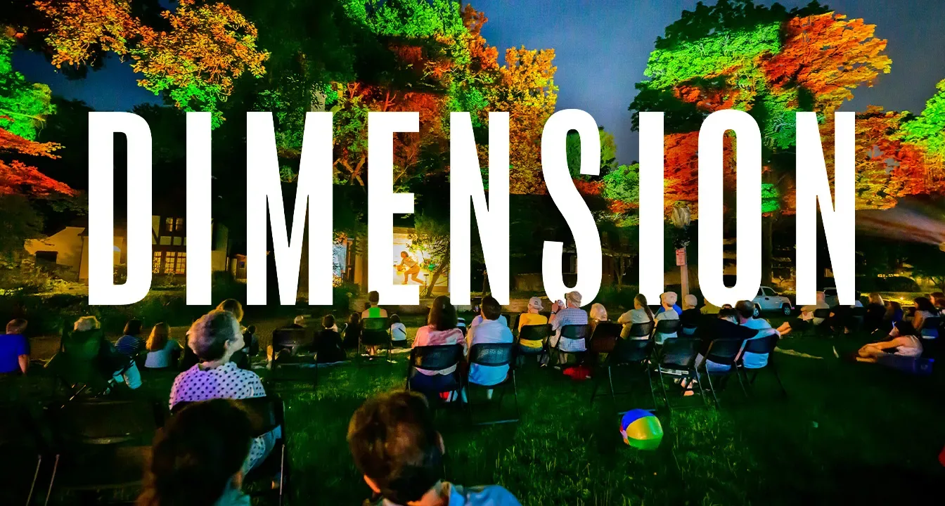 DIMENSION type amongst people on lawn in front of projections