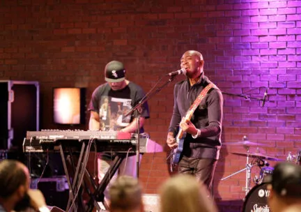 person singing and playing guitar