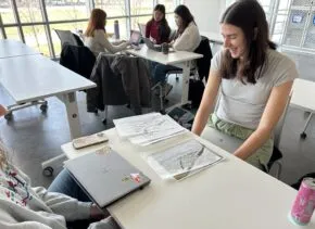person sitting and working at table
